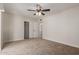 Cozy bedroom features neutral carpet, ceiling fan with lights, and closet with sliding door at 1413 E Dobbins Rd, Phoenix, AZ 85042