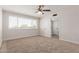 Bedroom features carpet, window with blinds, and ceiling fan with lighting fixture at 1413 E Dobbins Rd, Phoenix, AZ 85042
