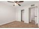 Bedroom showcasing carpet, ceiling fan, closet with sliding doors, and entry to the bathroom at 1413 E Dobbins Rd, Phoenix, AZ 85042