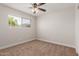 Bedroom with carpet, a window overlooking the mountains, and a ceiling fan with lighting at 1413 E Dobbins Rd, Phoenix, AZ 85042