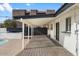 Backyard view highlighting covered patio, exposed brick pavers, and privacy fence at 1421 W Pasadena Ave, Phoenix, AZ 85013