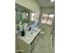 Modern bathroom with white vanity, black fixtures, and decorative marble-patterned hexagon tile flooring at 1421 W Pasadena Ave, Phoenix, AZ 85013