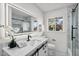 Bright bathroom featuring quartz counters, dark hardware, and modern finishes at 1421 W Pasadena Ave, Phoenix, AZ 85013