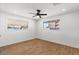 Bright bedroom featuring wood floors, a ceiling fan, and natural light from a window at 1421 W Pasadena Ave, Phoenix, AZ 85013