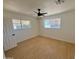 A bright bedroom with light wood flooring, two windows, ceiling fan and neutral paint color at 1421 W Pasadena Ave, Phoenix, AZ 85013