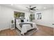 Cozy bedroom featuring wood floors, a ceiling fan, and a comfortable bed at 1421 W Pasadena Ave, Phoenix, AZ 85013