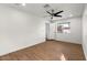 Spacious bedroom with light wood floors, a ceiling fan, and a large window at 1421 W Pasadena Ave, Phoenix, AZ 85013