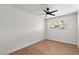 Cozy bedroom featuring wood floors, a ceiling fan and a window for natural light at 1421 W Pasadena Ave, Phoenix, AZ 85013