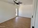 Empty bedroom offers a ceiling fan, light walls, and access to the backyard with a white door at 1421 W Pasadena Ave, Phoenix, AZ 85013