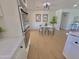 Bright dining area with neutral decor, a modern light fixture, and access to the kitchen at 1421 W Pasadena Ave, Phoenix, AZ 85013