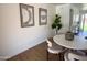 Bright dining area features modern artwork, a round table with seating for four, and views to the outside at 1421 W Pasadena Ave, Phoenix, AZ 85013