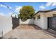 Charming single-story home boasts a manicured yard, a black metal gate and a well-maintained brick driveway at 1421 W Pasadena Ave, Phoenix, AZ 85013