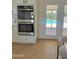 Modern kitchen with double ovens and a view of the pool; perfect for cooking and entertaining at 1421 W Pasadena Ave, Phoenix, AZ 85013