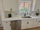 Bright kitchen sink and counter, featuring black hardware and view to the pool and outdoor area at 1421 W Pasadena Ave, Phoenix, AZ 85013