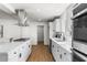Updated kitchen showcasing sleek stainless appliances and seamless flow to an open concept living and dining area at 1421 W Pasadena Ave, Phoenix, AZ 85013