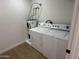 Bright laundry room with stacked washer and dryer units plus water heater; great space-saving solution at 1421 W Pasadena Ave, Phoenix, AZ 85013