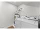 Functional laundry room with a stacked washer and dryer, offering convenience and efficiency at 1421 W Pasadena Ave, Phoenix, AZ 85013