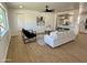 Bright living room features modern furniture, ceiling fan, and an open floor plan that flows into the kitchen at 1421 W Pasadena Ave, Phoenix, AZ 85013