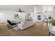 Open-concept living room showcasing hardwood floors, modern furniture, and seamless flow to the kitchen and dining area at 1421 W Pasadena Ave, Phoenix, AZ 85013