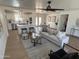 Open concept living area featuring a modern white sofa, stylish chair, and view into the kitchen and dining area at 1421 W Pasadena Ave, Phoenix, AZ 85013