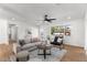 Bright living room featuring hardwood floors, a cozy sofa, and a large window offering natural light at 1421 W Pasadena Ave, Phoenix, AZ 85013
