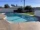 Backyard view of sparkling swimming pool with surrounding patio and a green lawn at 1421 W Pasadena Ave, Phoenix, AZ 85013
