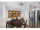 Bright dining area with a dark wood table and stainless steel refrigerator at 15221 N Clubgate Dr # 2096, Scottsdale, AZ 85254