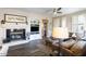 Bright living room featuring a fireplace, ceiling fan, and contemporary furnishings at 15221 N Clubgate Dr # 2096, Scottsdale, AZ 85254