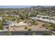 Aerial view of the house and neighborhood featuring mature landscaping, tiled roof, and neighborhood street at 1530 E Loma Ln, Phoenix, AZ 85020