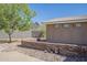 This backyard shows mature landscaping, a brick retaining wall, and a view of the mountain at 1530 E Loma Ln, Phoenix, AZ 85020
