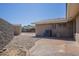 Cozy backyard featuring decorative gravel, block fencing, and a covered patio at 1530 E Loma Ln, Phoenix, AZ 85020