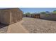 Backyard features a storage shed, privacy fence, and decorative rock at 1530 E Loma Ln, Phoenix, AZ 85020