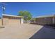 Backyard showing concrete area, landscaping, a detached garage, and a connected house at 1530 E Loma Ln, Phoenix, AZ 85020
