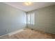Cozy bedroom featuring a neutral carpet, and a window with wood shutters at 1530 E Loma Ln, Phoenix, AZ 85020