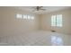 Tile floored bedroom with natural light and a ceiling fan at 1530 E Loma Ln, Phoenix, AZ 85020