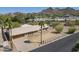 Spacious home featuring a tile roof, a large driveway, and palm trees at 1530 E Loma Ln, Phoenix, AZ 85020