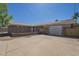 Spacious home exterior featuring a large driveway and a well-maintained yard with a privacy wall at 1530 E Loma Ln, Phoenix, AZ 85020