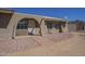 Exterior front door under an archway with gravel landscaping at 1530 E Loma Ln, Phoenix, AZ 85020