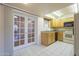 Kitchen with tile floors, skylight, wood cabinets, and doorway to dining area at 1530 E Loma Ln, Phoenix, AZ 85020