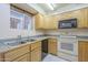 Efficient kitchen with tile floors, wood cabinets, ample counter space, and modern appliances at 1530 E Loma Ln, Phoenix, AZ 85020
