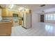 Bright kitchen and living area with tile floors, skylight, and ample cabinet space at 1530 E Loma Ln, Phoenix, AZ 85020