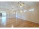 Bright living room featuring hardwood floors, ceiling fans, and a neutral paint scheme at 1530 E Loma Ln, Phoenix, AZ 85020