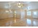 Spacious living room with hardwood floors, ample natural light, and multiple ceiling fans at 1530 E Loma Ln, Phoenix, AZ 85020