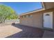 This view shows a covered patio space with a brick floor and access to an outdoor door at 1530 E Loma Ln, Phoenix, AZ 85020