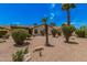 Spacious backyard showcasing desert landscaping, mature trees, and a charming covered patio area at 1549 N La Rosa Dr, Tempe, AZ 85288