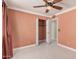 Bedroom with ceiling fan, closet, tile floors and soft peach walls at 1549 N La Rosa Dr, Tempe, AZ 85288