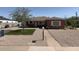 Charming single-story brick home with low-maintenance gravel landscaping and a green artificial lawn at 1721 W Earll Dr, Phoenix, AZ 85015