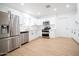 Bright and renovated kitchen featuring white cabinetry, stainless steel appliances, and recessed lighting at 1721 W Earll Dr, Phoenix, AZ 85015