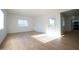 Bright living room with new vinyl floors, fresh white paint, and abundant natural light at 1721 W Earll Dr, Phoenix, AZ 85015