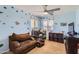 Delightful bedroom with dinosaur themed decor, featuring a crib and cozy furnishings for a playful space at 18182 W Desert Ln, Surprise, AZ 85388